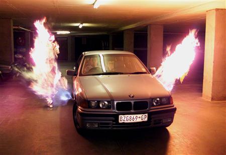 Charl Fourie, cooperating with the South African police, demonstrates an anti-hijacking "Blaster" flame-thrower in Johannesburg in this December 11, 1998 file photo
